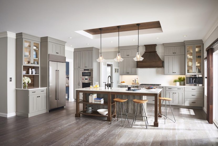 A modern updated kitchen complete with an accent colored island, butlers pantry and hanging fixture box