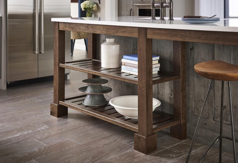 a custom open shelf at the end of a kitchen island