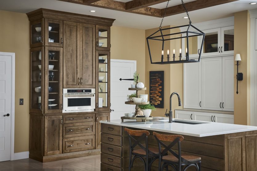 a kitchen butler pantry with wine storage and a built in plate warmer