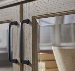 a detail shot of high end beveled glass cabinet doors with matte black hardware