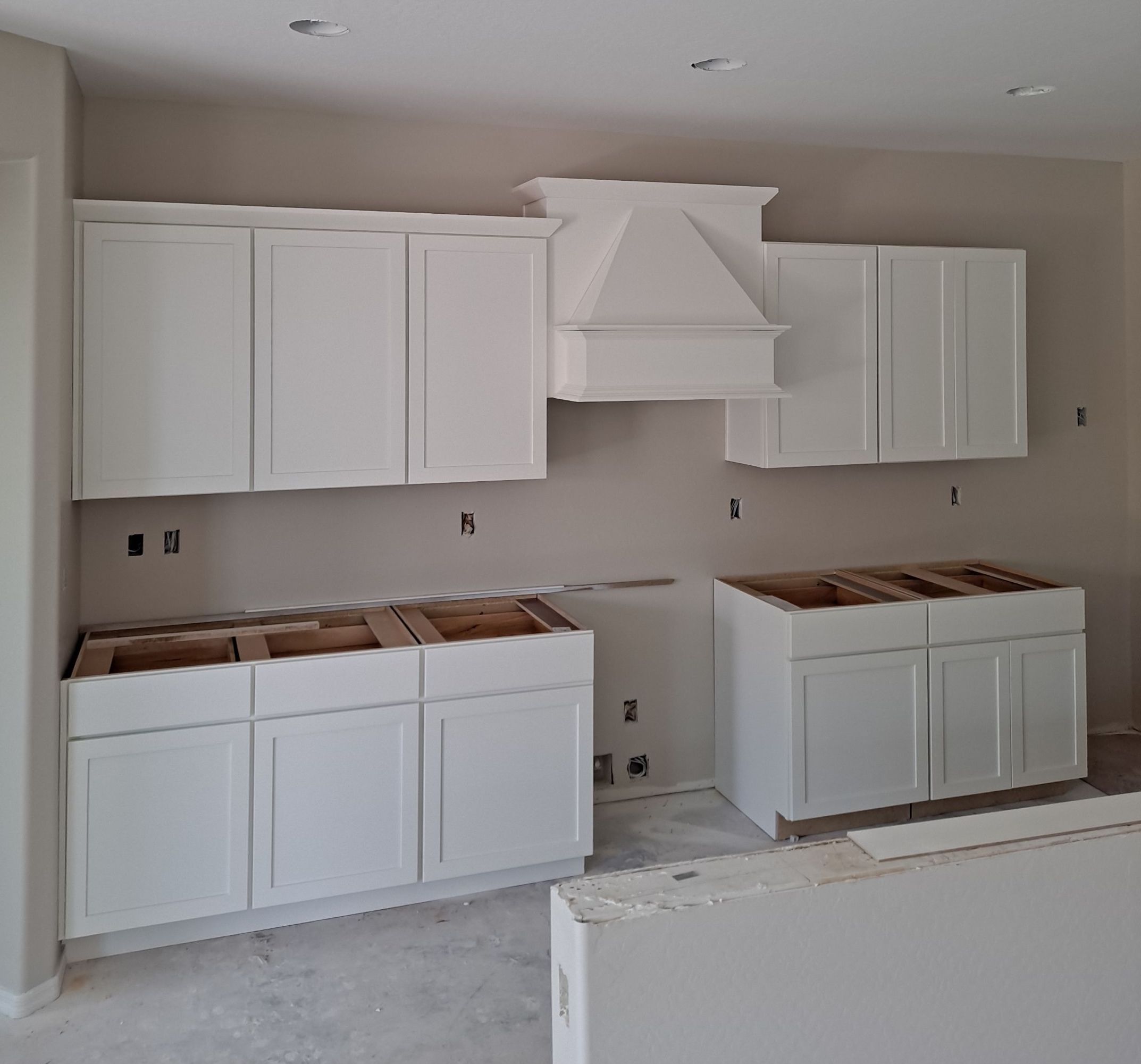 Kitchen being restored with new drywall and cabinetry