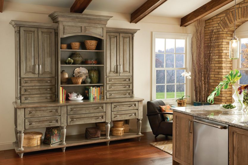 a warm sunlit kitchen with a custom hutch in a contrasting finish