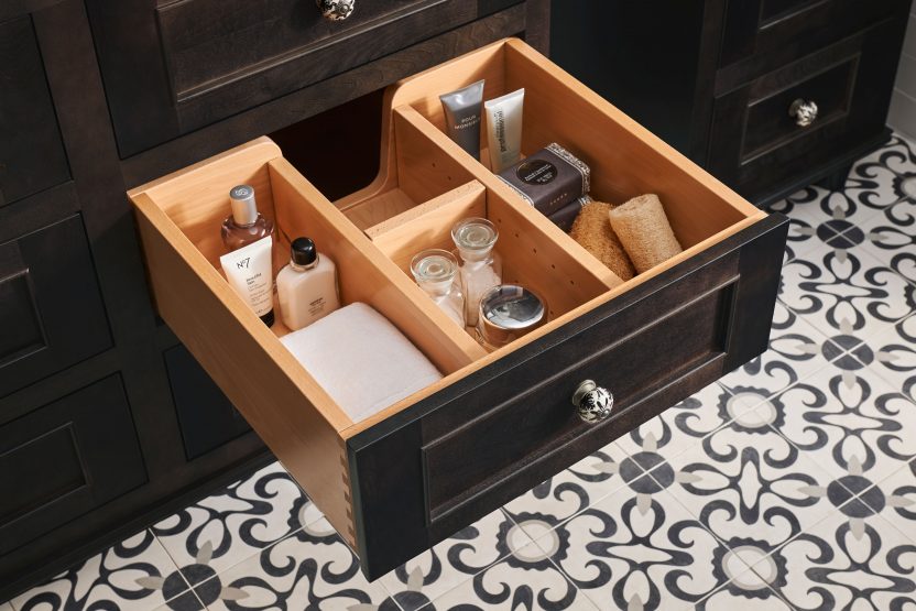 a custom bathroom drawer with organizing slots built in for toiletries